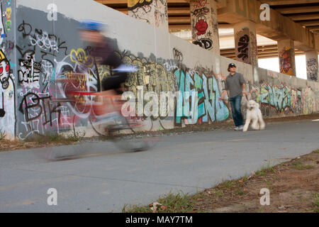 Motion blur of people exercising along a graffiti covered trail that is part of the Atlanta Beltline, on November 2, 2013 in Atlanta, GA.