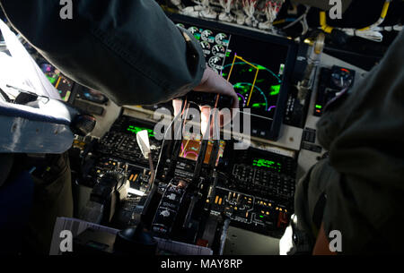 Maj. Jessie Salazar, 384th Air Refueling Squadron pilot, pulls the engine throttle of a KC-135 Stratotanker during Red Flag 18-2 at Nellis Air Force Base, Nevada, March 13, 2018. Red Flag allows pilots and aircrew to train in contested, degraded and operationally limited environments. (U.S. Air Force photo/Senior Airman Janelle Patiño) Stock Photo