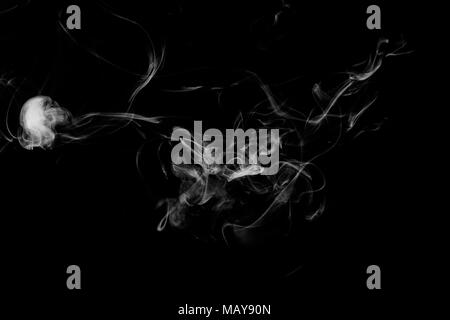 Cloud of white smoke on a black isolated background. Background from the smoke of vape Stock Photo