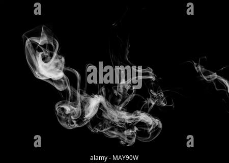 Cloud of white smoke on a black isolated background. Background from the smoke of vape Stock Photo