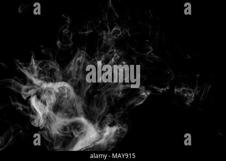 Cloud of white smoke on a black isolated background. Background from the smoke of vape Stock Photo