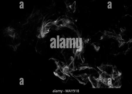 Cloud of white smoke on a black isolated background. Background from the smoke of vape Stock Photo