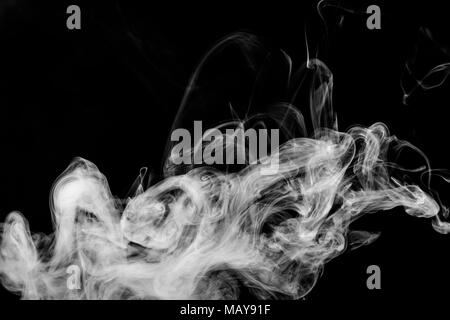 Cloud of white smoke on a black isolated background. Background from the smoke of vape Stock Photo