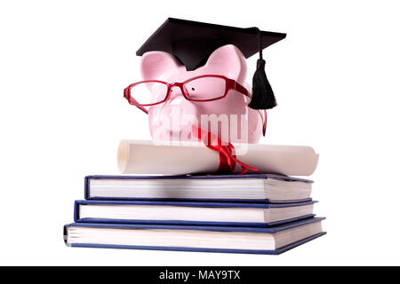 Pink piggy bank dressed as a college graduate with mortar board, glasses and diploma standing on a small stack of books.  Isolated on white. Stock Photo