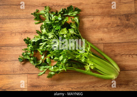 a bunch of celery on the wooden table - closeup Stock Photo