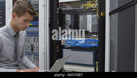 Technician performing maintenance tasks in a server room rack Stock Photo
