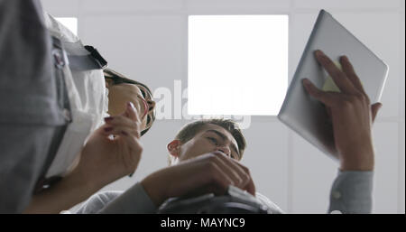 Technicians using laptop while analyzing server in server room Stock Photo