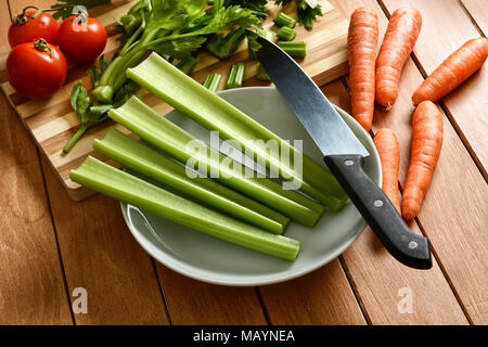 celery, carrots and tomato with knife beside - closeup Stock Photo