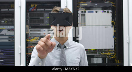 young IT engeneer using virtual reality headset over server room background Stock Photo