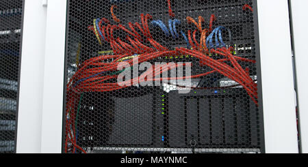 Detail of a communications rack, cables, switches and network Stock Photo