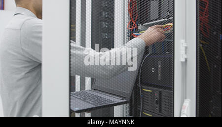 IT expert checking supercomputer server Stock Photo