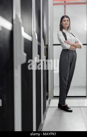 Technicians using laptop while analyzing server in server room Stock Photo