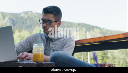 Hipster young man wearing sunglesses working outside of the office. Stock Photo