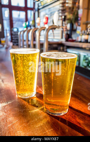 Close up of two pints of lager on the bar of a pub, UK, London Stock Photo