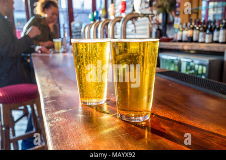 Close up of two pints of lager on the bar of a pub, UK, London Stock Photo