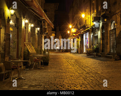 Illuminated Old Town lane at night, with restaurants, Dinan, Cotes-d'Armor, Brittany, France Stock Photo