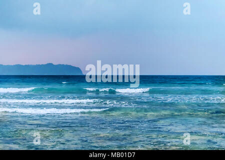 few clouds and blue sky with sea. sea in the evening light. Stock Photo