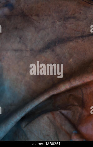 Abstract closeup detail of a weathered tarpaulin with colors  Stock Photo