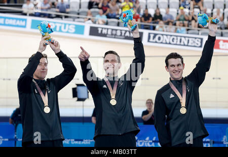 New Zealand's Ethan Mitchell (left), Edward Dawkins (centre) and Sam Webster on the podium with their gold medals after the Men's Team Sprint Finals Gold Medal Race at the Anna Meares Velodrome during day one of the 2018 Commonwealth Games in the Gold Coast, Australia. Stock Photo