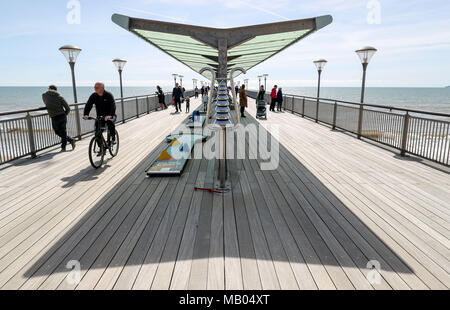 People enjoy the sunny weather on Boscombe pier in Bournemouth, Dorset. Stock Photo