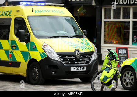 Three medical vehicles parked together, one ambulance van, one bicycle and one medical car attend a emergency in Kingston. Stock Photo