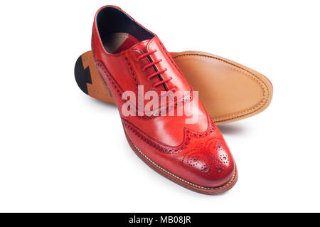 Studio shot of a mans red leather brogue isolated on white - John Gollop Stock Photo