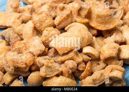 Pork scratchings from a packet bought in a supermarket. UK Stock Photo