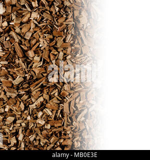 Dark brown wood chips create abstract rough-textured organic background surface Stock Photo
