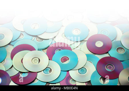 Random colorful DVD and CD disks create data concept background with gradation Stock Photo