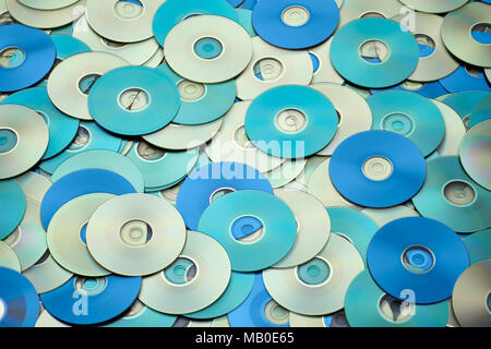 Random arrangement of silver blue DVD and CD disks create data concept background Stock Photo