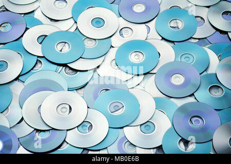 Random arrangement of blue grey DVD and CD disks create data concept ...