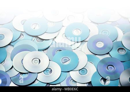 Random arrangement of blue grey DVD and CD disks create data concept background Stock Photo