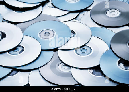 Random silver and grey DVD and CD disks create data concept background Stock Photo