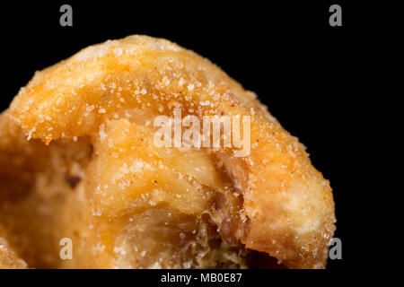 A pork scratching from a packet bought in a supermarket. UK Stock Photo