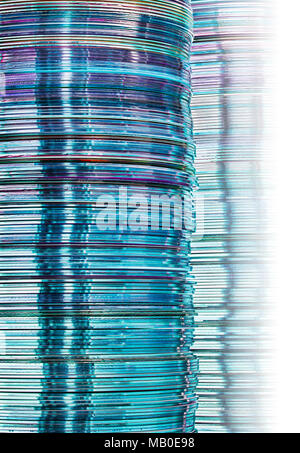 Stacks of cool blue translucent DVD and CD computer storage disks create conceptual data technology background with gradation Stock Photo