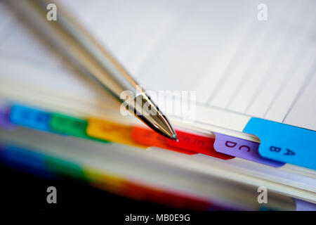 Selective focus alphabetical index address book with mechanical pencil. Stock Photo