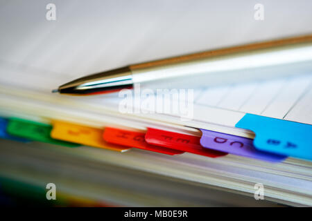 Selective focus alphabetical index address book with mechanical pencil. Stock Photo