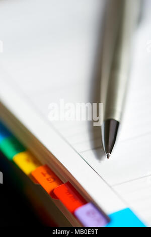 Selective focus alphabetical index address book with mechanical pencil. Stock Photo