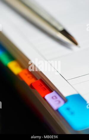 Selective focus alphabetical index address book with mechanical pencil. Stock Photo