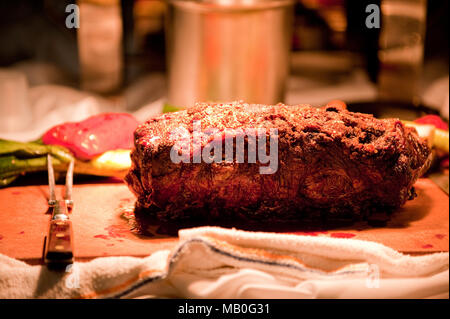 A big piece of steak on a cutting board ready to be served at a party Stock Photo