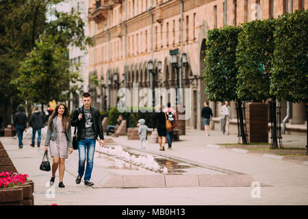 Minsk, Belarus - June 28, 2017: Young People Couple Walking On Lenina Street In Summer Evening. Stock Photo