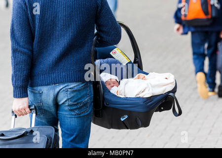 England, London, Man Carrying New born Baby in Basket Stock Photo