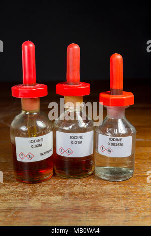 A line of three iodine dropper bottles (0.02M, 0.01M and 0.0025M), as used in a UK secondary school, London, UK. Stock Photo