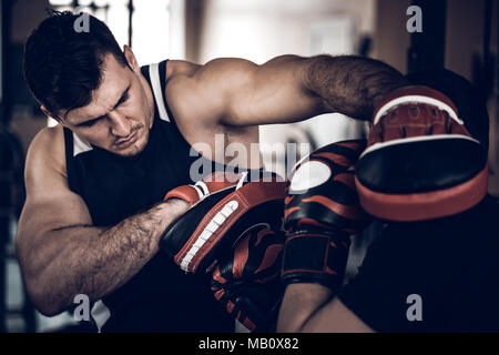 Boxing workout with trainer and punch mitts Stock Photo