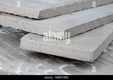 Laying and cutting tiles. Tools and building materials at a working position. Tiles for industrial and technical applications. Material Gres. Stock Photo