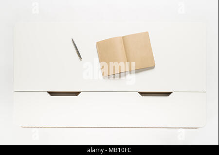 Notebook on white table in white background Stock Photo