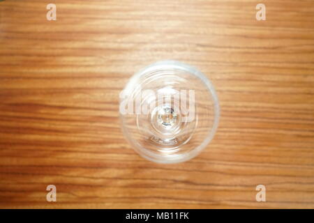Empty wine glass, isolated on a brown background table Stock Photo