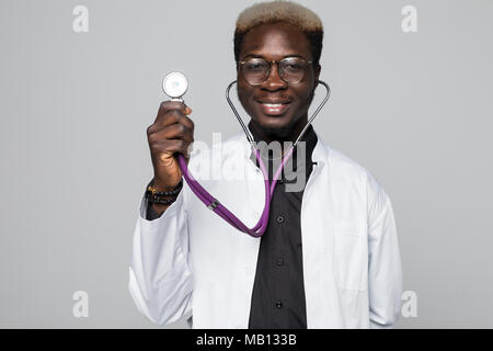 Portrait of handsome Afro American doctor with sthethoscope in white coat looking at camera, isolated on gray Stock Photo