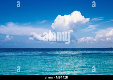 the Caribbean. A saturated blue sky, clouds and the sea. Stock Photo