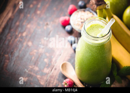 Close-up of green fresh smoothie with fruits, berries, oats and seeds, selective focus. Detox, dieting, clean eating, vegetarian, vegan, fitness, heal Stock Photo